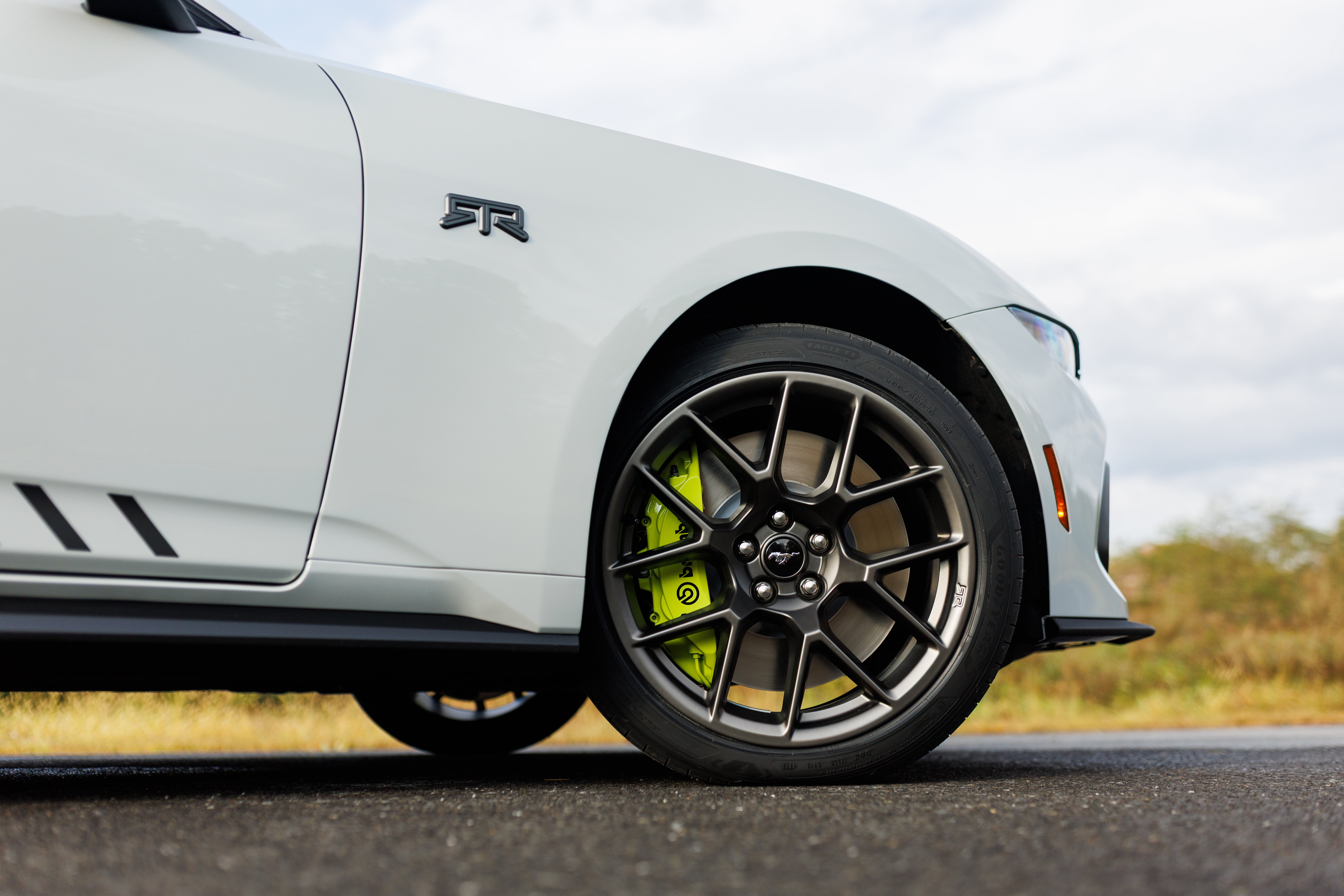 Optional RTR package available on 2026 Ford Mustang EcoBoost fastback. Preproduction model shown with optional Hyper Lime brake caliper shown. Available late spring 2026.